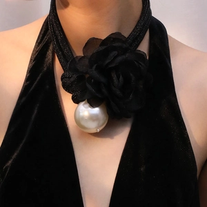 Retro black chiffon flower necklace with a large white pearl pendant on elegant model