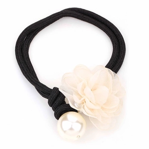 Detail of elegant black braided headband featuring a cream fabric flower and large pearl