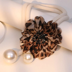 Leopard print fabric flower tieback with black rhinestones and white pearl accents