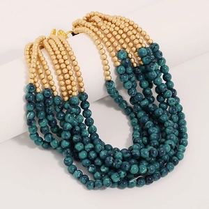 Detail of bohemian multilayer beaded necklace with gold and green marble beads
