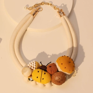 Artistic insect and mushroom necklace with woven rope and yellow ladybug pendant