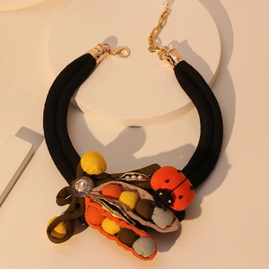 Handmade chunky rope necklace featuring fabric pea pod charms and a red ladybug pendant