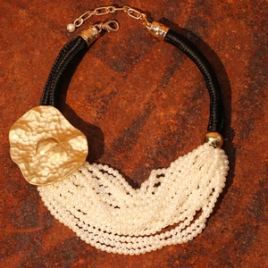 Multilayer faux pearl necklace with large hammered gold flower pendant and black woven cord