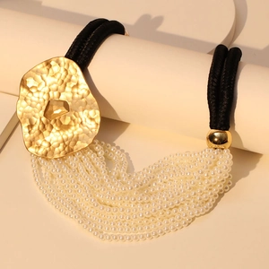 Elegant multi-layer pearl necklace with a large irregular gold hammered metal pendant