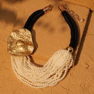 Elegant multi-layer faux pearl necklace with large irregular hammered gold pendant
