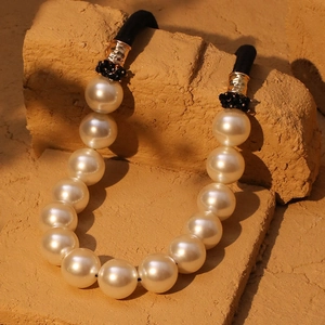 Elegant chunky faux pearl necklace with gold-tone hammer textured metal and black cord