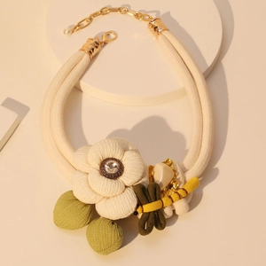 Artistic pastoral necklace with white fabric flower and dragonfly on woven rope