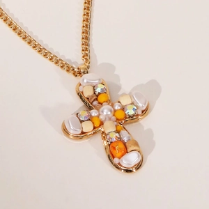 Bohemian gold chain necklace featuring a colorful mixed-bead cross pendant design