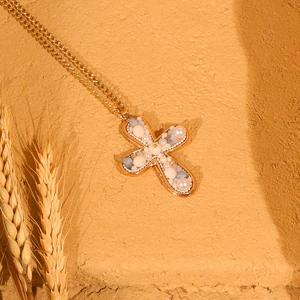 Cross pendant necklace with pearls and colorful stones on a vintage golden chain