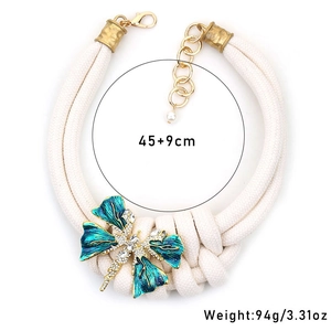Detail of chunky double-layer rope necklace with rhinestone butterfly and enamel dragonfly
