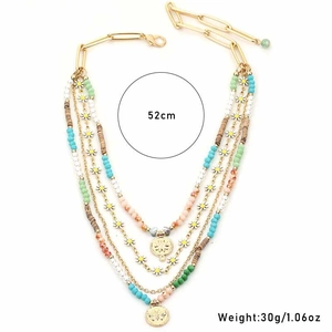 Detail of layered daisy necklace with colorful beads and golden sunburst pendants