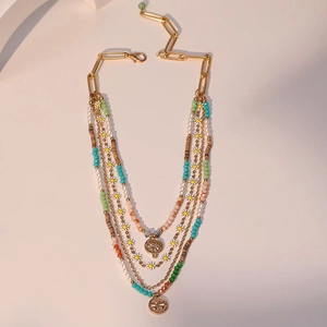 Detail of layered bohemian necklace with daisy charms and colorful handmade beads
