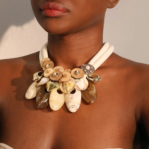 Detailed view of handmade statement necklace featuring coconut shell and resin elements