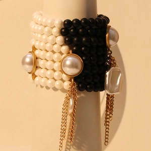 Multilayer black and white beaded bracelet with imitation pearl tassels and gold metal accents