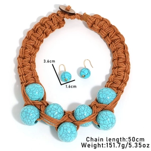 Detail view of handmade bohemian braided rope necklace with turquoise stone pendant and beads