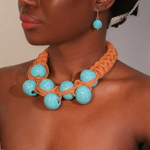 Handmade woven cord necklace and turquoise bead earring set on a female model