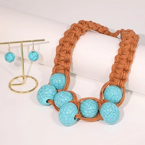 Detail of handmade woven necklace and earrings with synthetic turquoise stone beads