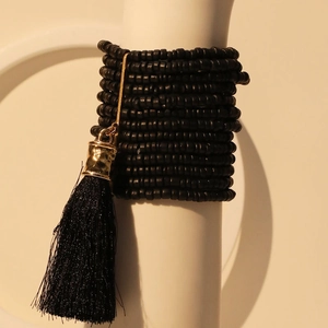Handmade multilayer black beaded bracelet with gold charms and bohemian tassel accent