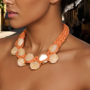 Handmade chunky orange rope necklace with beige resin geometric beads on a model