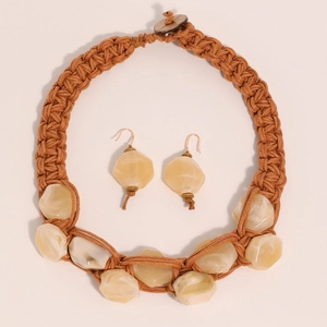 Detail of handmade woven thick rope necklace and resin earrings set in warm brown tones