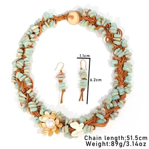 Detalle del conjunto de collar bohemio de piedra natural tejida a mano con flores y mariposa