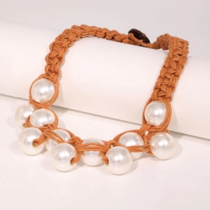 Handmade chunky rope necklace with white pearls on a minimalist white display