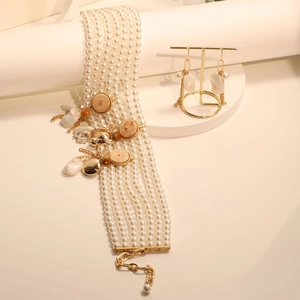 Elegant multi-layer pearl necklace and earring set on a minimalist white display