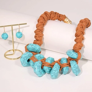 Detailed view of handmade woven necklace with turquoise stones and matching bead earrings