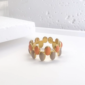 Golden oval enamel open ring with coral pink and grey wave pattern design