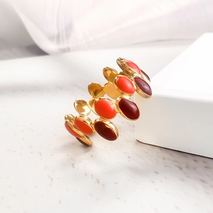 Detail of colorful enamel dripping oil oval blocks on a gold-plated stainless steel ring