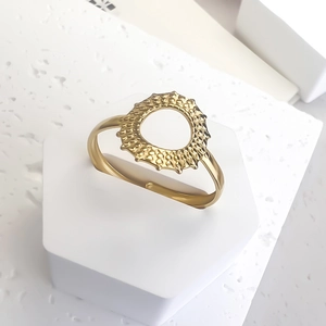 Adjustable gold stainless steel ring featuring a radiant sunburst circle ornament
