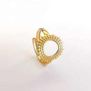Detailed view of sun-inspired adjustable gold ring with unique spiked texture and open band