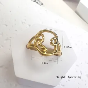 Minimalist gold stainless steel ring featuring a hollow abstract face portrait design