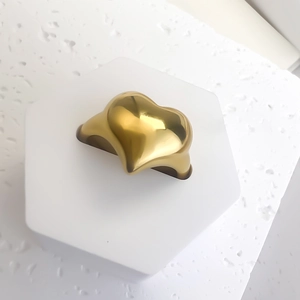 Detailed macro shot of a heart-shaped 18K gold plated chunky stainless steel open ring