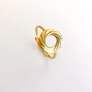 Detail shot of a minimalist gold hollow ring with a sleek twisted metal spiral design