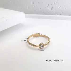 Minimalist gold-plated wave pattern ring with a round clear sparkling zirconia stone