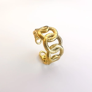 Macro detail of gold-plated chain link ring featuring a vintage hammered rock texture finish