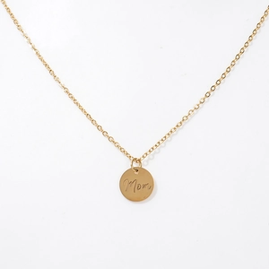 Close-up of golden MOM necklace with hollow round pendant on a fine O-chain links