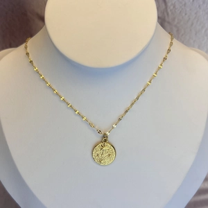 French vintage gold stainless steel necklace with star relief coin pendant on neck model
