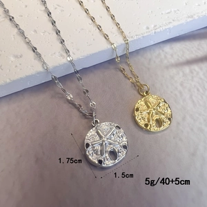 Golden and silver starfish shell pendant necklace in stainless steel with ocean texture