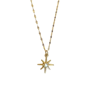 Golden stainless steel necklace with octagram star pendant and opal stone on white background