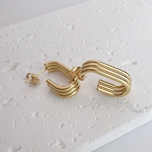 Minimalist 18K gold plated multi-layer stainless steel earrings on white stone surface