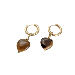Minimalist heart earrings featuring golden hoop design and dark amber resin stone pendants