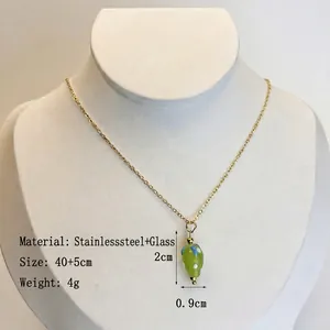 Collier doré en acier inoxydable avec pendentif fraise en verre à pois sur mannequin