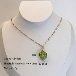 Gold stainless steel necklace featuring a green glass flower pendant with pink details