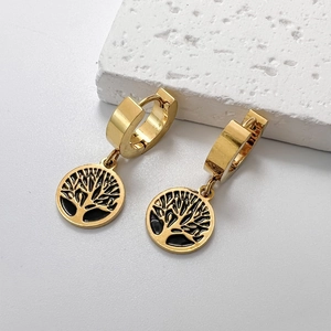 Gold stainless steel hoop earrings with black enamel tree of life pendants on white stone