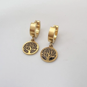 Macro detail of golden tree of life drop earrings with black enamel and leverback design