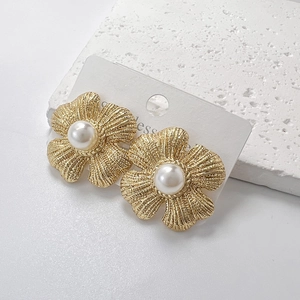 Golden matte flower earrings with pearl center in stainless steel on display card