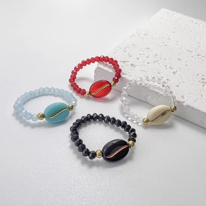 Elegant beaded elastic rings with coffee bean charms in blue, red, white, and black
