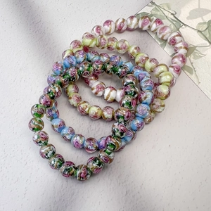 Bracelet artisanal en perles avec roses pastel et feuilles d'or au style pastoral français